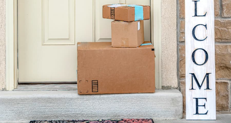 Boxes by the door of a residence with a welcome sign in Binghamton